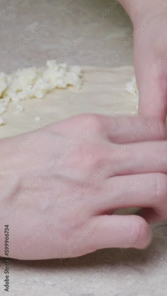 young woman prepares traditional khachapuri with egg. Dough and cheese, put in the oven Vertical video. young woman prepares traditional khachapuri with egg. Dough and cheese, put in the oven Vertical video.