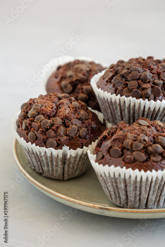 Homemade Dark Chocolate Muffins on a Plate, low angle view. Close-up.