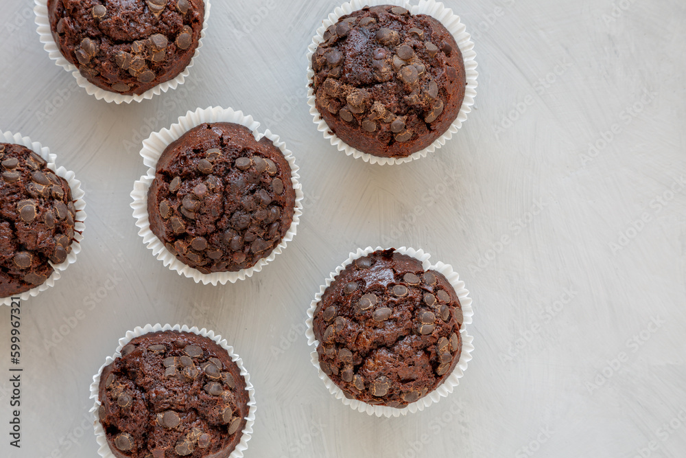 Homemade Dark Chocolate Muffins on a gray background, top view. Overhead, from above, flat lay. Space for text. Homemade Dark Chocolate Muffins on a gray background, top view. Overhead, from above, flat lay. Space for text.