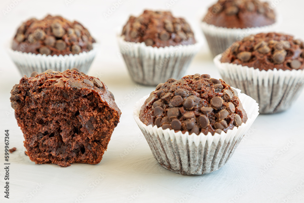 Homemade Dark Chocolate Muffins on a gray background, side view. Close-up. Homemade Dark Chocolate Muffins on a gray background, side view. Close-up.