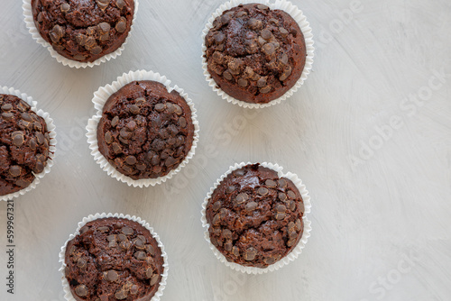 Homemade Dark Chocolate Muffins on a gray background, top view. Overhead, from above, flat lay. Space for text.