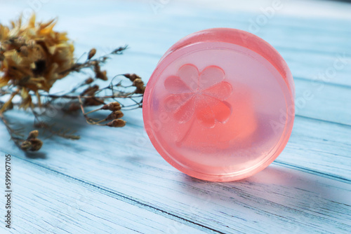 Pink glycerin soap on the background is old wood., Product care about clean and soft body skin., Daily beauty product. photo