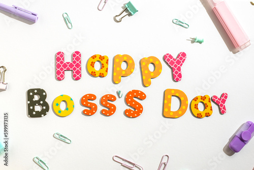 Fotografija The inscription Happy Boss's day from colored letters on white