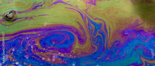 colored stains of gasoline oil on the water  iridescence