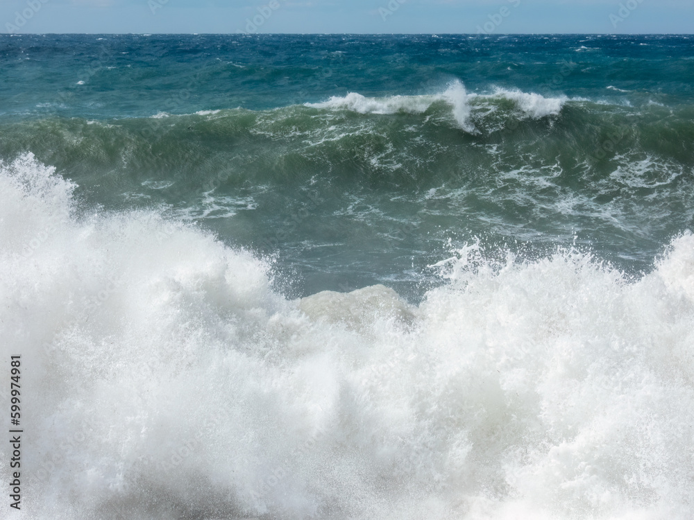 Large waves breaking on shore in Mediterranian sea during storm