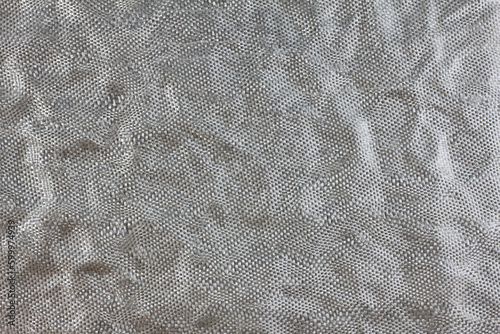 Silver rumpled background with foil texture