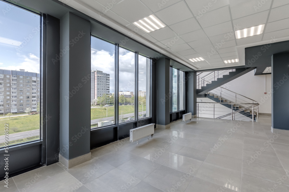 Fototapeta premium empty modern hall room with columns, doors and panoramic windows.