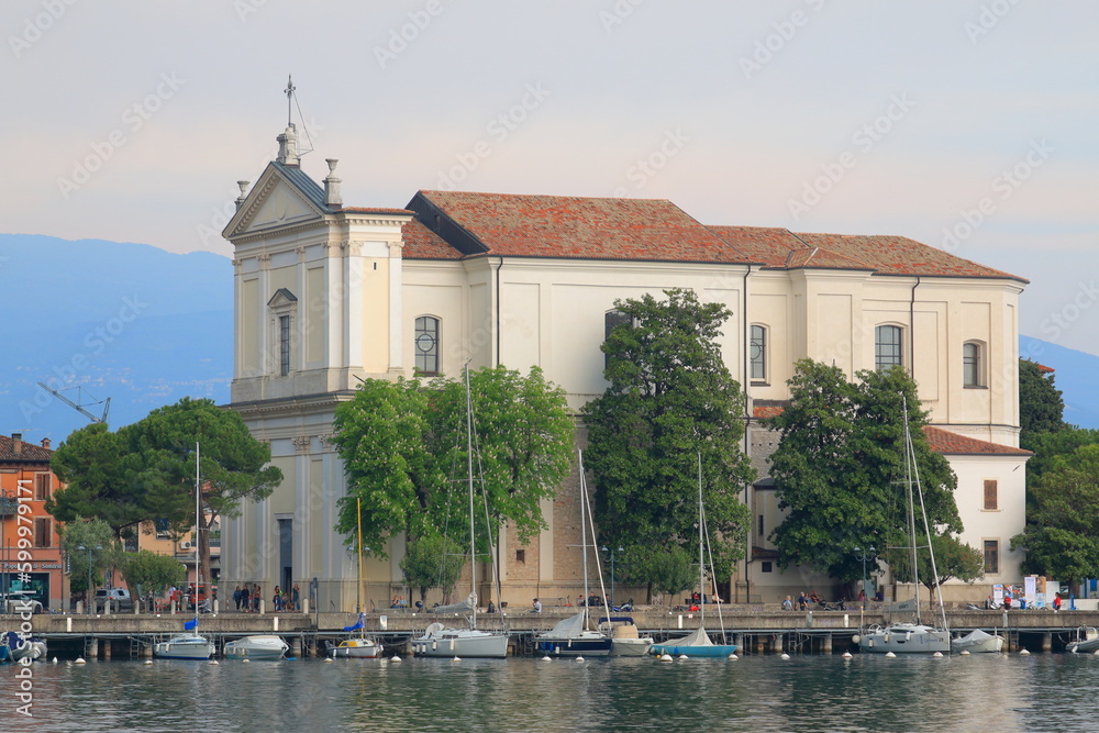 Seafront of the city of Maderno with a pier and a view of the Cathedral of Sant'Andrea Apostolo