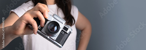 Girl holding an old camera in her hand