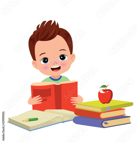 Little boy reading a book with a red apple on the table