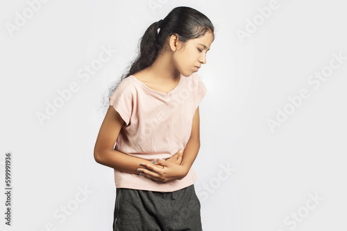 Photography slim indian woman in casual wear clutching her stomach indicating menstrual pain