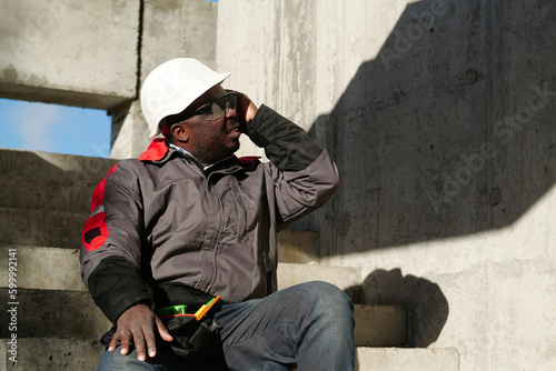 African american worker at project site has headache, he touches his head © Harmony Video Pro