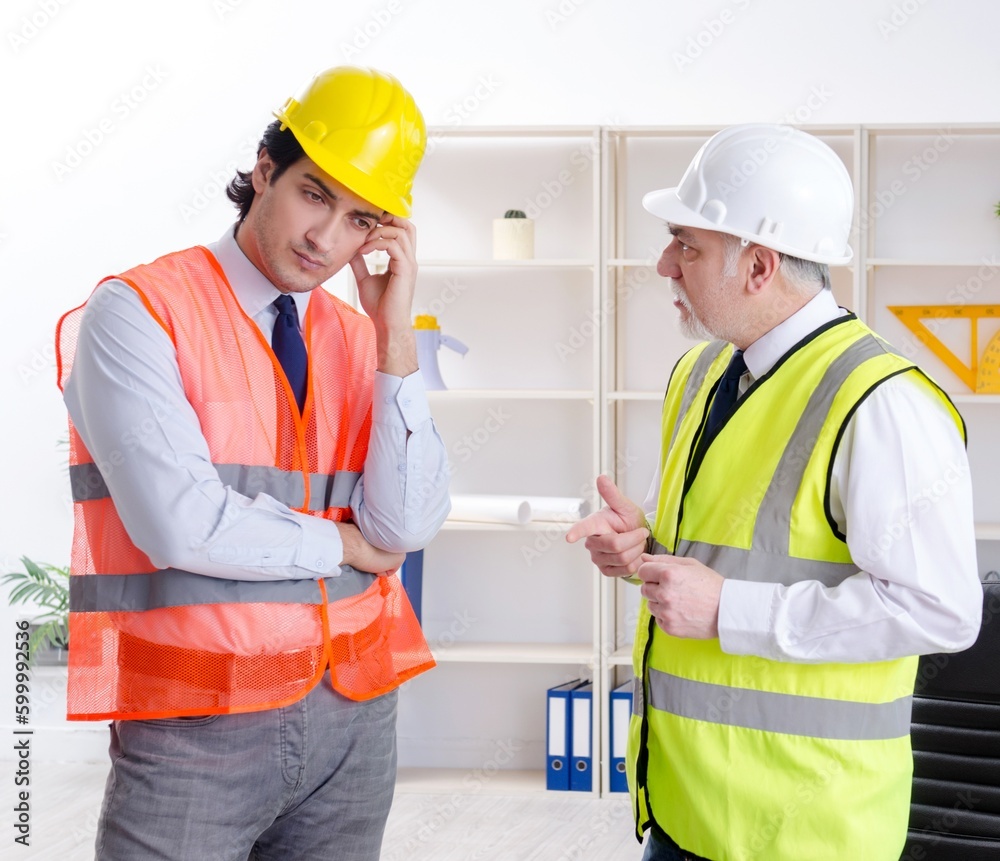 Two engineers colleagues working under project Two engineers colleagues working under project