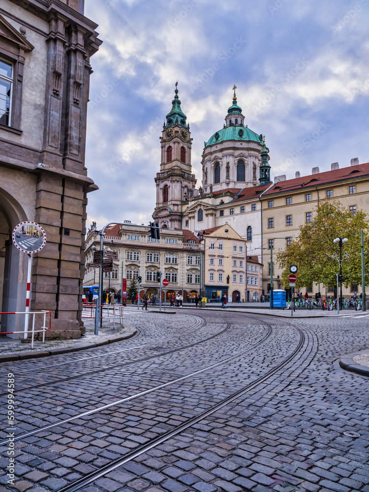 Prague paved street and the dome of Saint Francis Assisi Church during a cloudy, Czech Republic
