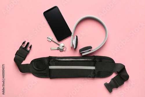 Flat lay composition with stylish black waist bag on pink background