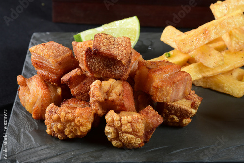 fried pork skin crackling pork pancetta pururuca typical brazilian food with lemon and french fries