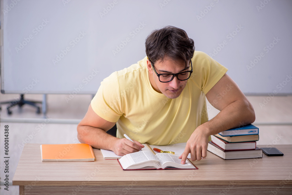 Young male student sitting in the classroom Young male student sitting in the classroom