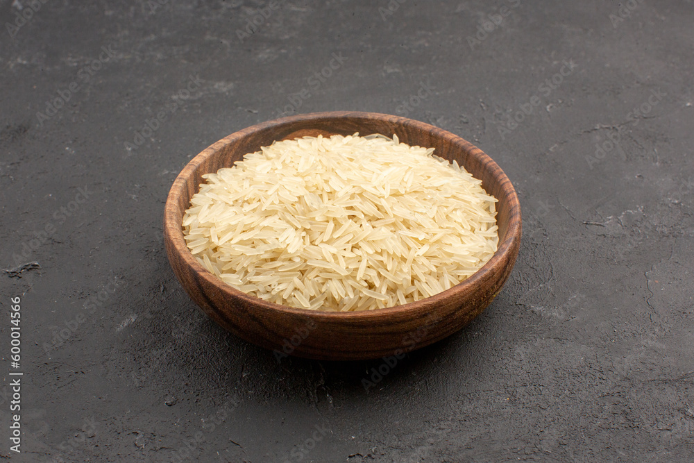 front view raw rice inside brown plate on grey background rice raw meal food east cooking front view raw rice inside brown plate on grey background rice raw meal food east cooking