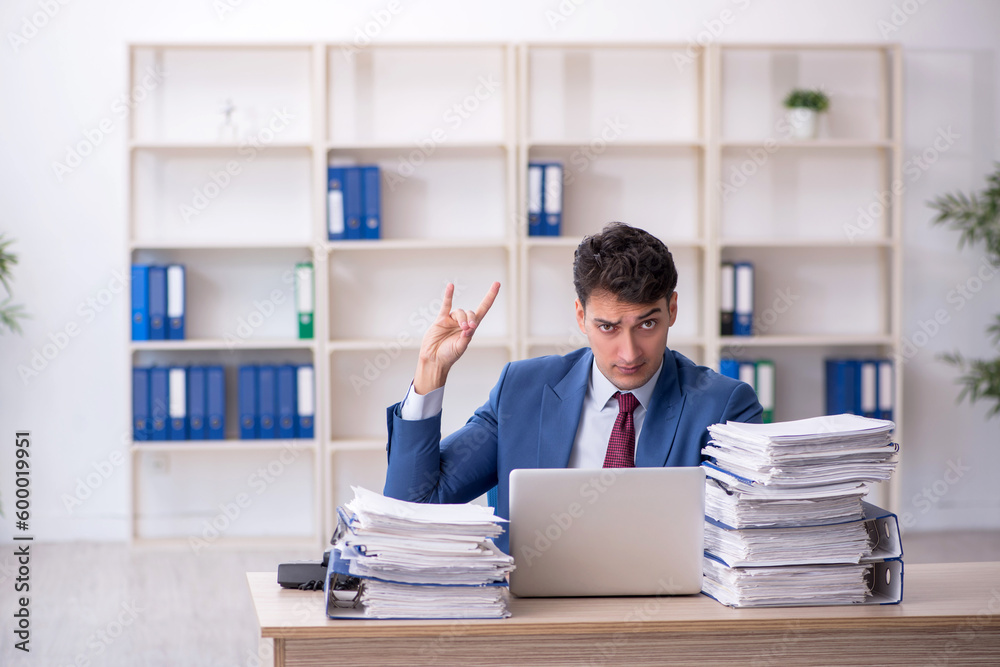 Young male employee working in the office Young male employee working in the office
