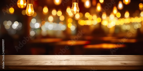Wooden table in front of abstract blurred restaurant lights background