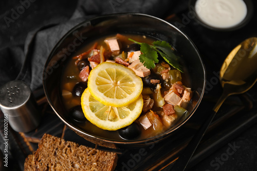 Bowl of tasty Hodgepodge soup on dark background