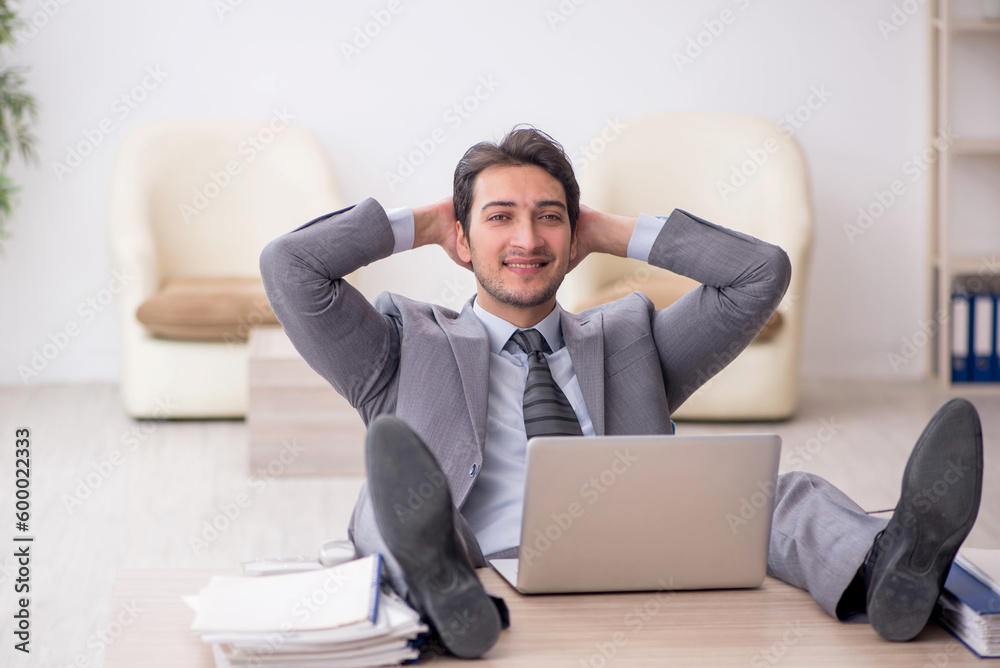 Young male employee working in the office