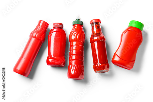 Bild auf Leinwand Assortment of red ketchup and hot sauce bottles with green and red caps, food co
