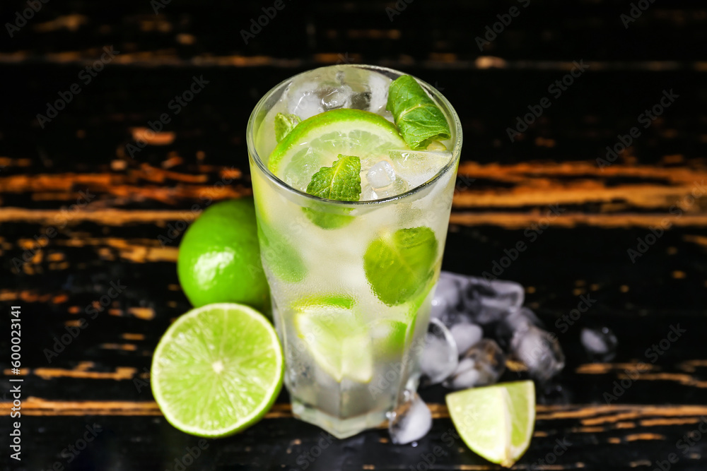 Glass of tasty mojito on dark wooden background Glass of tasty mojito on dark wooden background