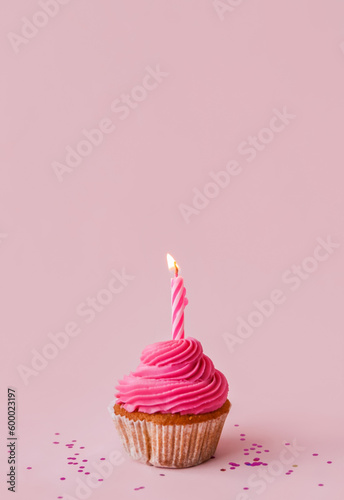 Tasty cupcake with birthday candle on lilac background