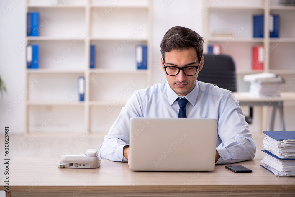 Young male employee working in the office Young male employee working in the office