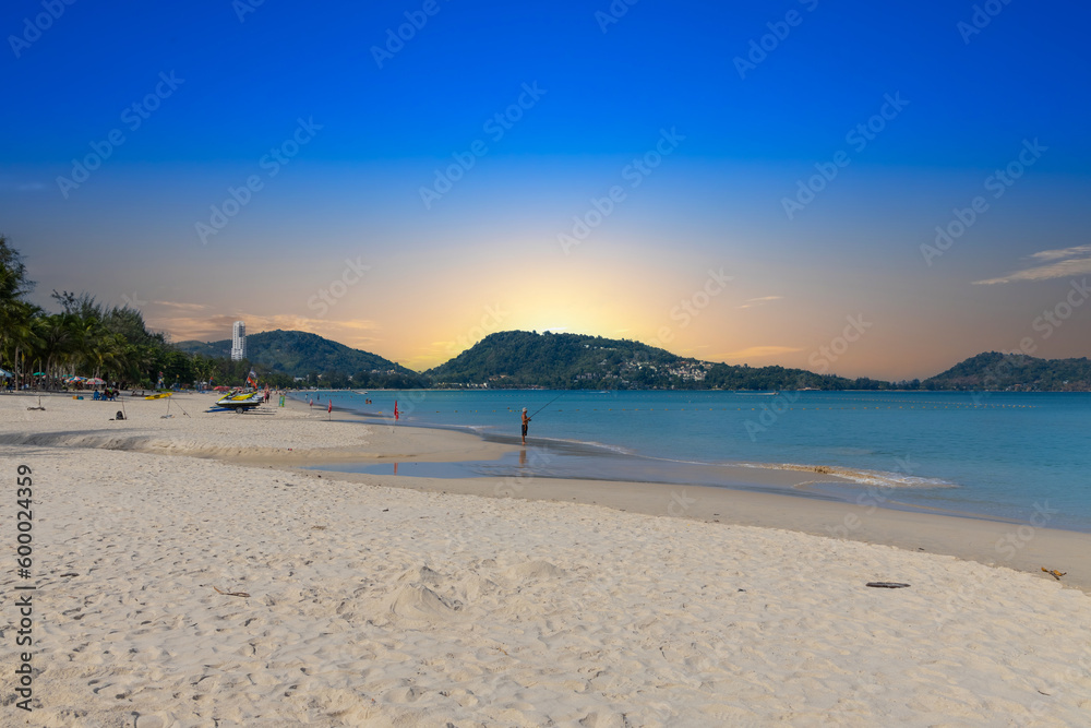 Patong Beach Phuket Thailand nice white sandy beach clear blue and turquoise waters and lovely blue skies with Palms tree sunset sunrise