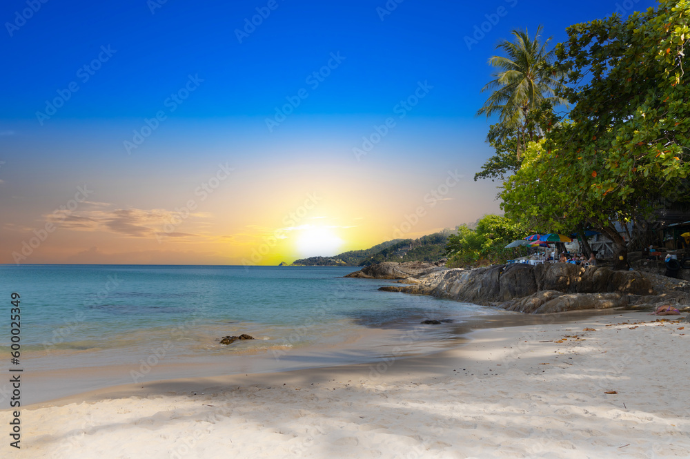 Patong Beach Phuket Thailand nice white sandy beach clear blue and turquoise waters and lovely blue skies with Palms tree sunset sunrise