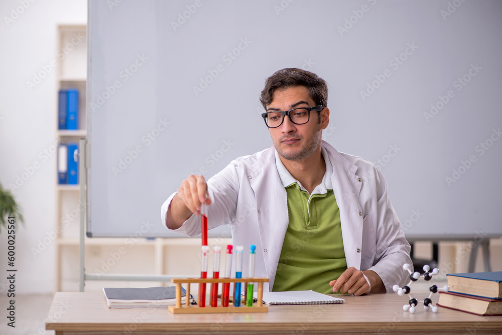 Young male chemist in the classroom Young male chemist in the classroom