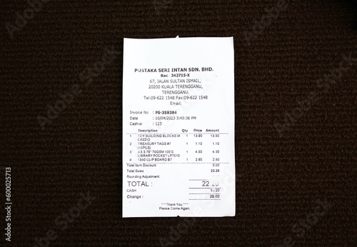 Paper sales receipt isolated on a dark background. proof of purchase concept photo