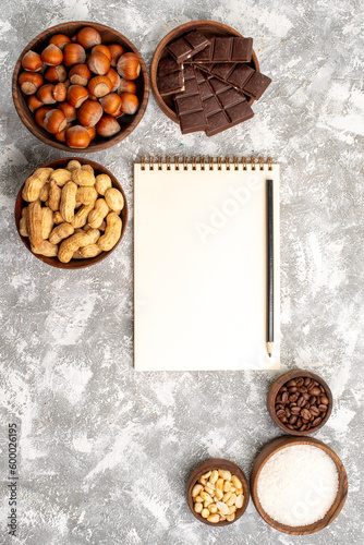 top view delicious chocolate bars with hazelnuts and peanuts on white background peanut nuts snack food