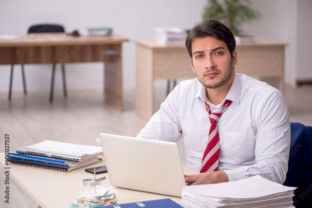 Young male employee working in the office Young male employee working in the office