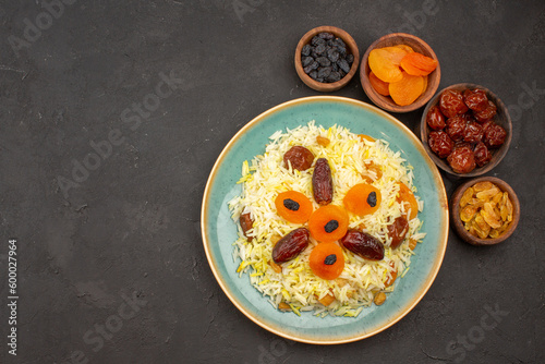 top view delicious cooked plov rice with different raisins inside plate on a grey background rice meal food dinner raisin cooking
