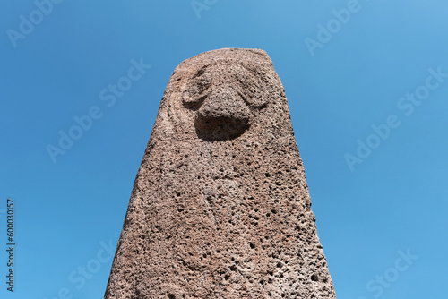 Portrait of Vishap (ancient Armenian god of water) on the background of blue sky. Armenia. photo