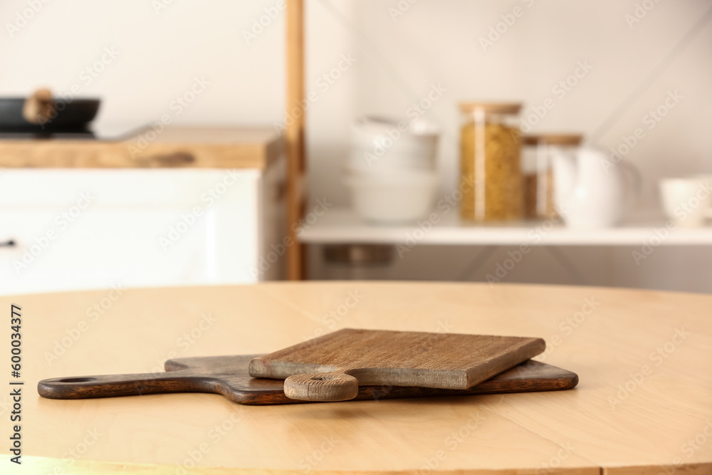 Cutting board on wooden table in kitchen