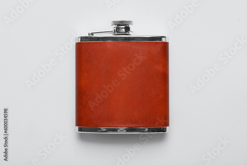 New hip flask on grey background photo