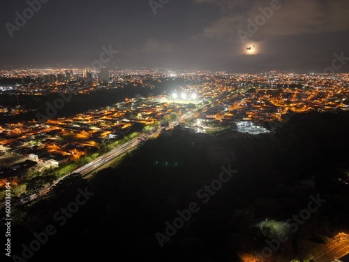 Experience the enchanting sight of the full moon rising over the iconic La Sabana Park and Costa Rica National Stadium, creating a mesmerizing and magical atmosphere