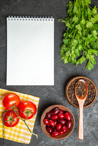 top view fresh greens with dogwoods and tomatoes on a grey background spicy hot copybook notepad