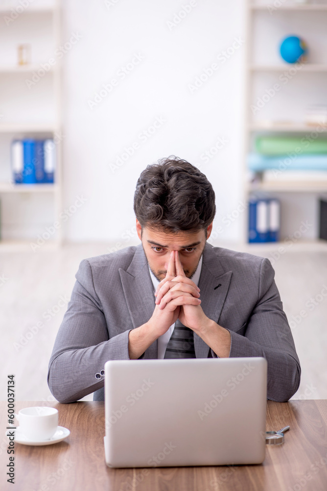 Young male employee working in the office