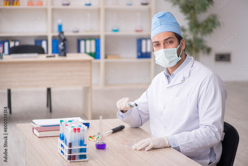 Young male chemist working at the lab Young male chemist working at the lab