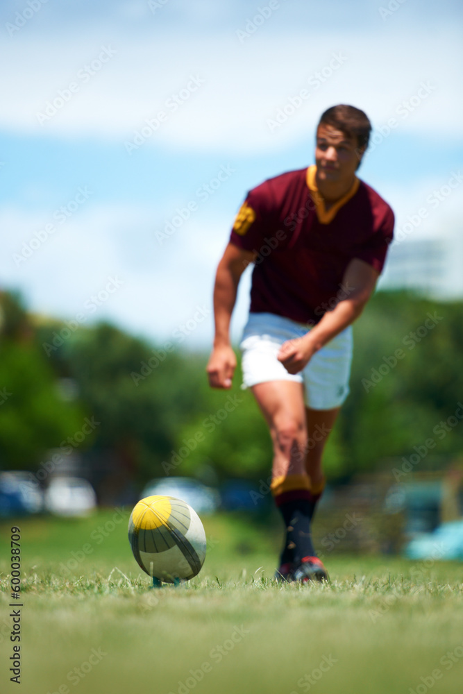 Sports, young rugby player kick a ball for conversion and in a field for a game or competition. Fitness or exercise, sportsman or training and professional male athlete playing on grass pitch outdoor