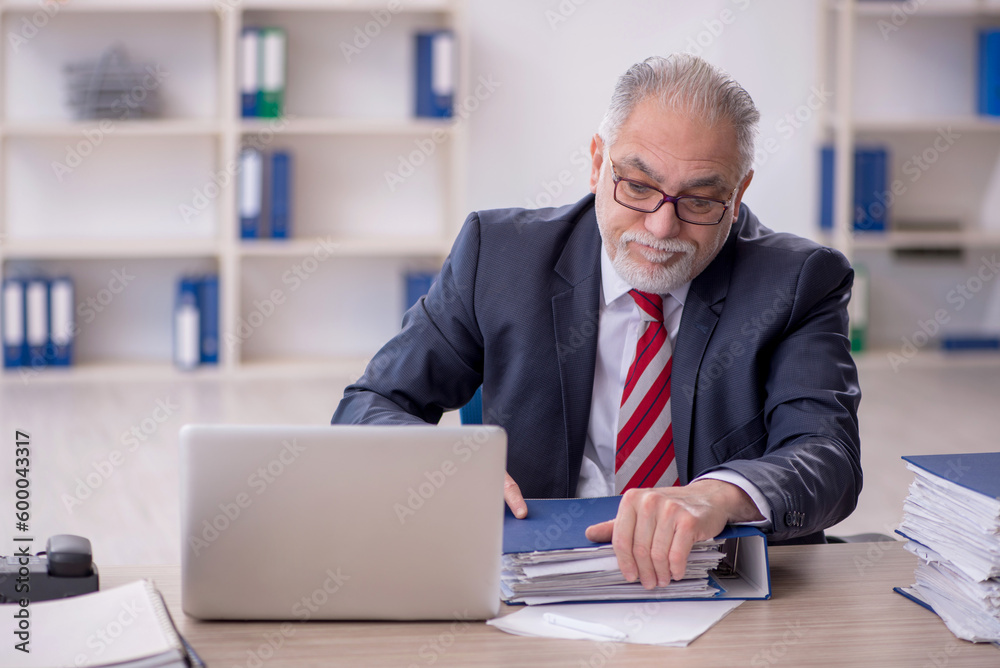 Old male employee and too much work in the office Old male employee and too much work in the office