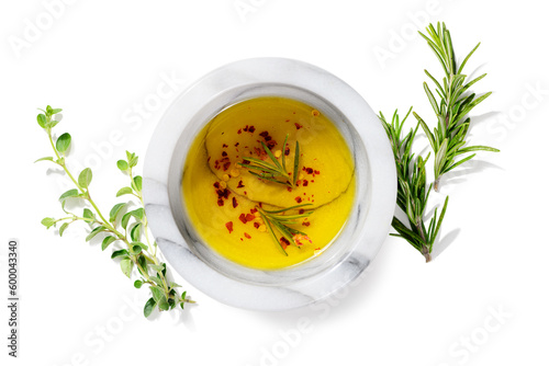 Bowl of spicy oil with fresh greens and spices, isolated on white. top view