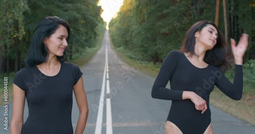 tired exhausted dancers take break, restying after workout outdoors, standing on the road, Slow motion photo