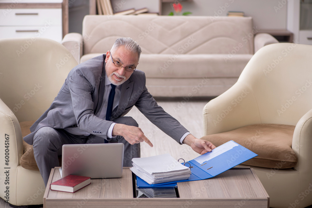Old male boss working from home during pandemic Old male boss working from home during pandemic