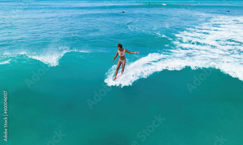 Black female surfer riding a wave